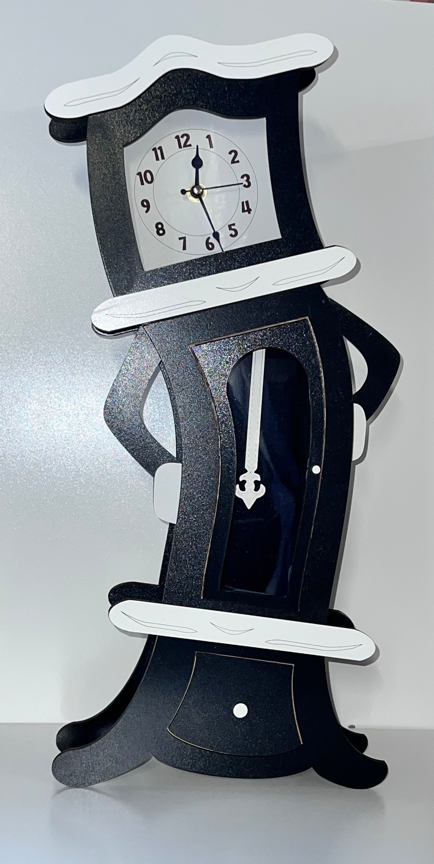 Tabletop tilting grandfather clock.